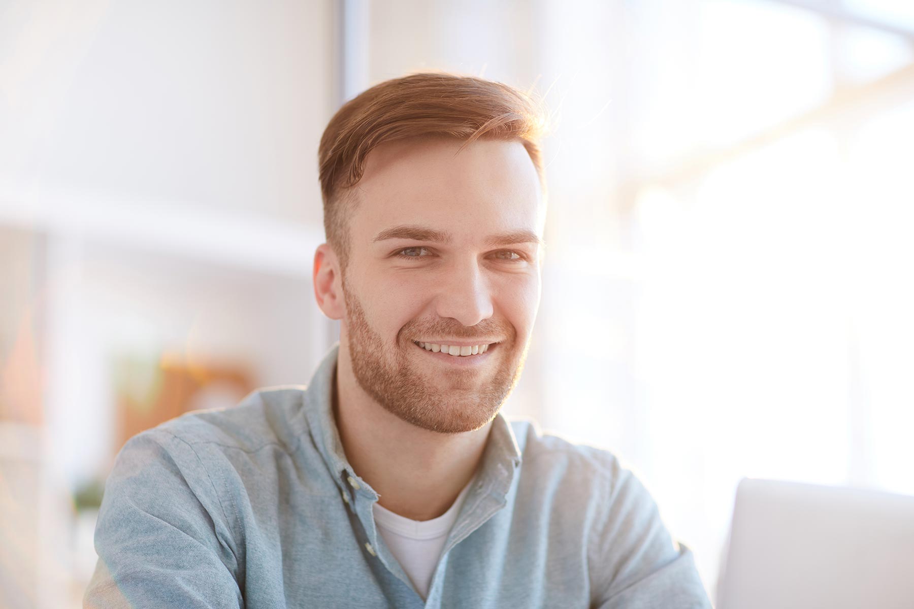 portrait-of-smiling-man-in-office-RKEFSHX.jpg